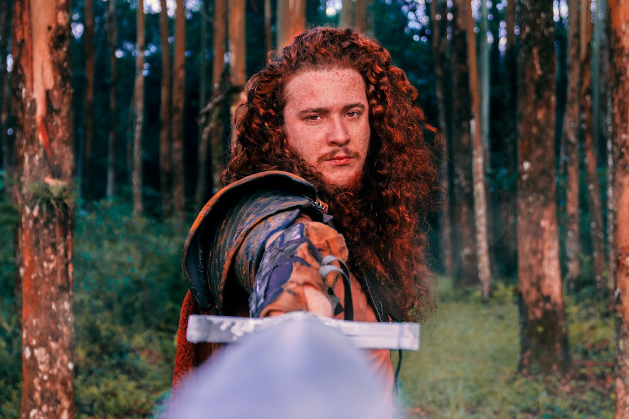 Portrait of a Viking warrior with red hair holding a sword in a Brazilian forest.